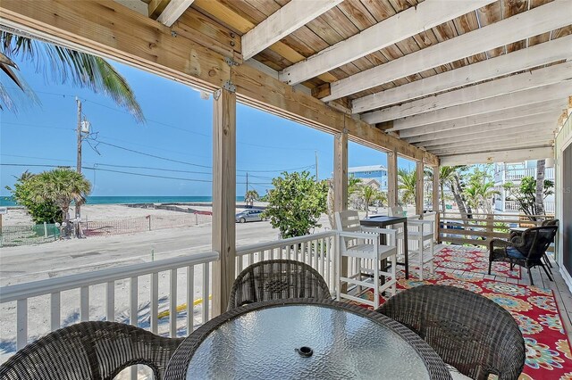 1103 Shore View Dr, Englewood, FL 34223 - sunroom with beam ceiling, outdoor dining area, and a water view