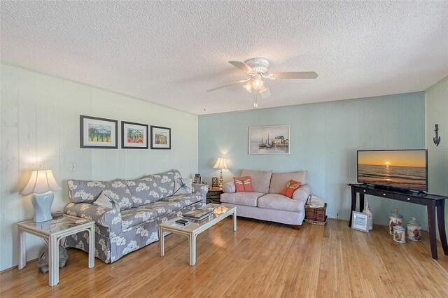 1103 Shore View Dr, Englewood, FL 34223 - living room with wood finished floors, ceiling fan, and a textured ceiling