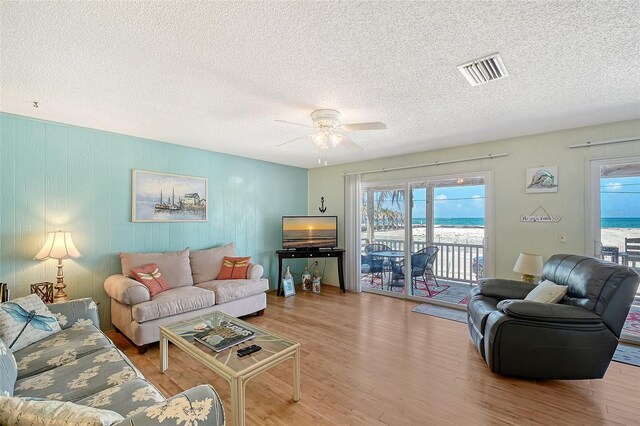 1103 Shore View Dr, Englewood, FL 34223 - living room featuring wood finished floors, healthy amount of natural light, a textured ceiling, and ceiling fan