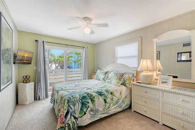 1103 Shore View Dr, Englewood, FL 34223 - carpeted bedroom with wooden walls and a ceiling fan