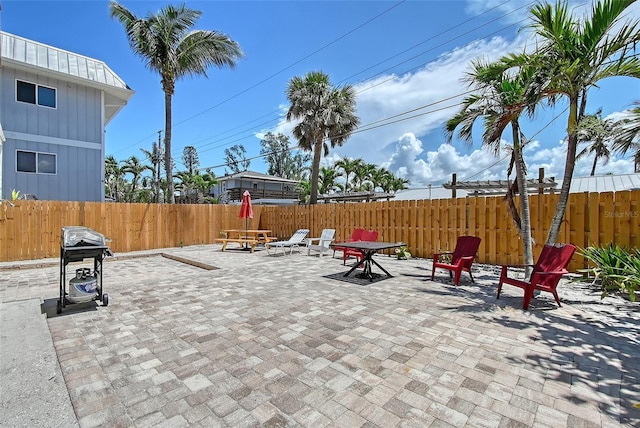 1103 Shore View Dr, Englewood, FL 34223 - fenced backyard featuring a patio area, a grill, and outdoor dining space
