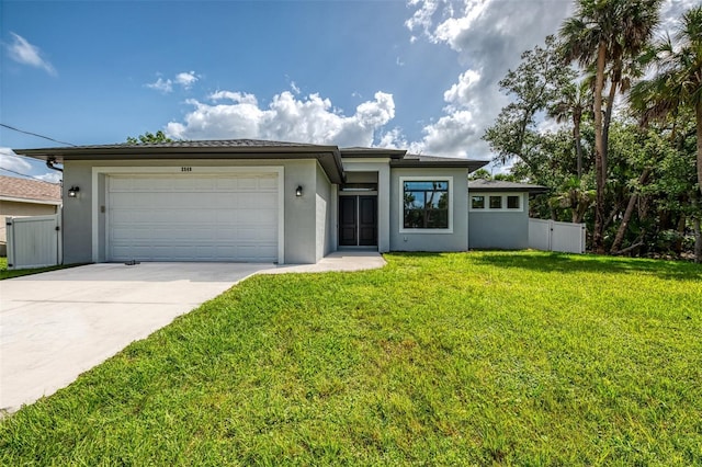 2546 Malibu Ln, North Port, FL 34286 - prairie-style home with stucco siding, driveway, and a garage