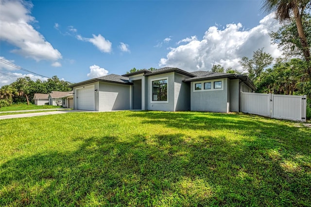 2546 Malibu Ln, North Port, FL 34286 - prairie-style home with stucco siding, a garage, driveway, and a gate