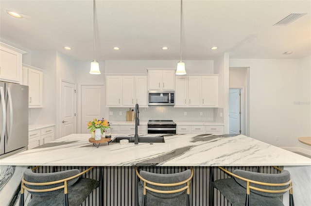 2546 Malibu Ln, North Port, FL 34286 - kitchen featuring stainless steel appliances, white cabinets, a sink, decorative light fixtures, and recessed lighting