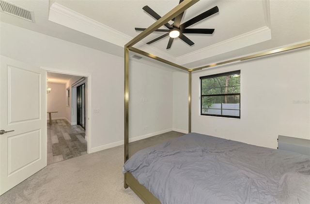 2546 Malibu Ln, North Port, FL 34286 - bedroom featuring a raised ceiling, crown molding, carpet flooring, and ceiling fan