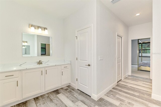 2546 Malibu Ln, North Port, FL 34286 - bathroom featuring vanity, wood finished floors, baseboards, and ensuite bathroom