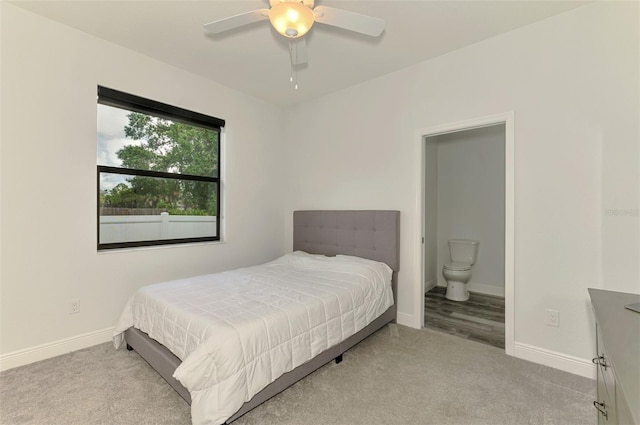 2546 Malibu Ln, North Port, FL 34286 - bedroom with carpet, baseboards, ensuite bath, and a ceiling fan