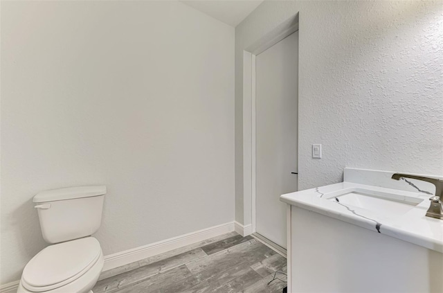 2546 Malibu Ln, North Port, FL 34286 - half bath featuring toilet, vanity, wood finished floors, and baseboards
