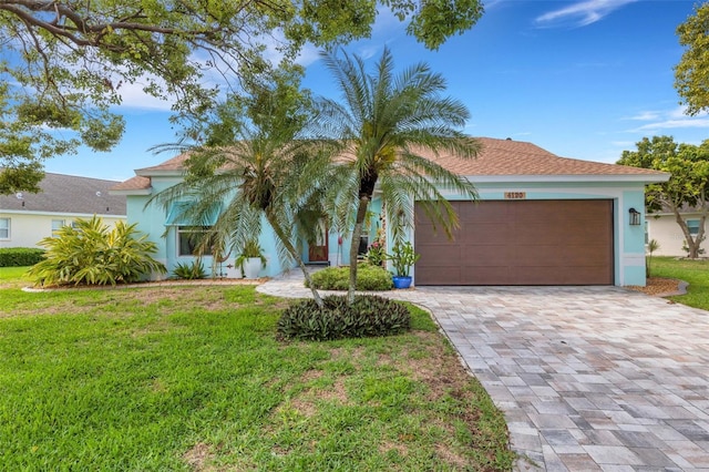 4120 51st Dr W, Bradenton, FL 34210 - view of front of property with a front yard, decorative driveway, a garage, and stucco siding
