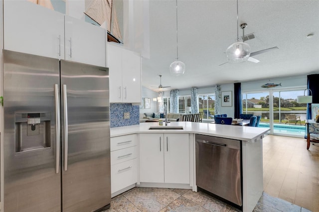 4120 51st Dr W, Bradenton, FL 34210 - kitchen with appliances with stainless steel finishes, ceiling fan, open floor plan, a peninsula, and light countertops