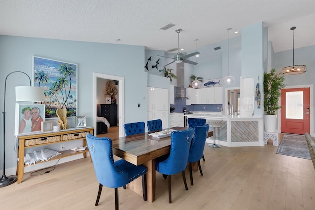 4120 51st Dr W, Bradenton, FL 34210 - dining area with light wood-style flooring, high vaulted ceiling, and a ceiling fan
