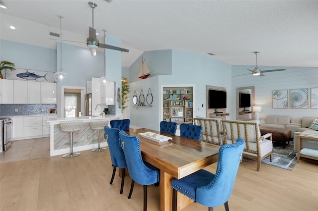 4120 51st Dr W, Bradenton, FL 34210 - dining area featuring ceiling fan, light wood-style flooring, and high vaulted ceiling