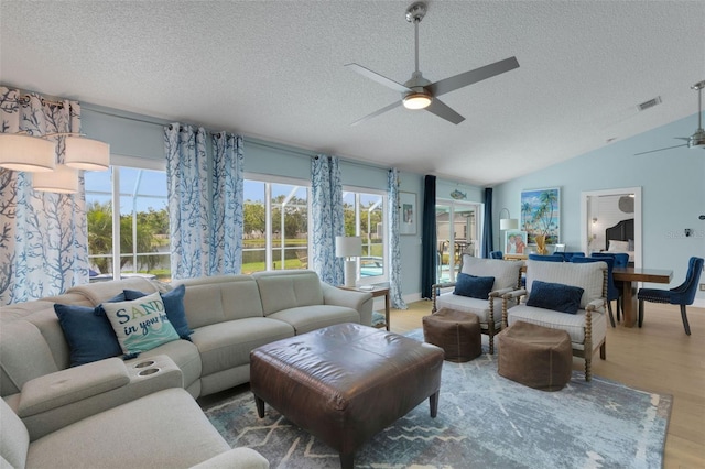 4120 51st Dr W, Bradenton, FL 34210 - living room with ceiling fan, a textured ceiling, plenty of natural light, wood finished floors, and lofted ceiling
