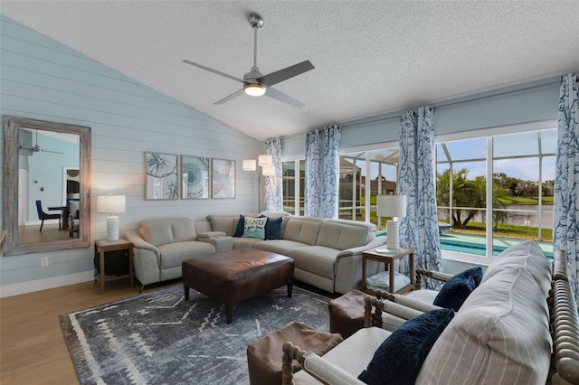 4120 51st Dr W, Bradenton, FL 34210 - living area featuring a ceiling fan, lofted ceiling, wood finished floors, a textured ceiling, and wooden walls