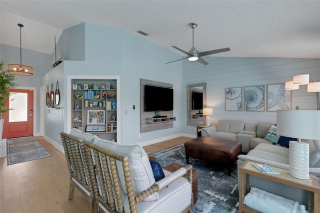 4120 51st Dr W, Bradenton, FL 34210 - living area with wood finished floors, a ceiling fan, a textured ceiling, high vaulted ceiling, and a chandelier