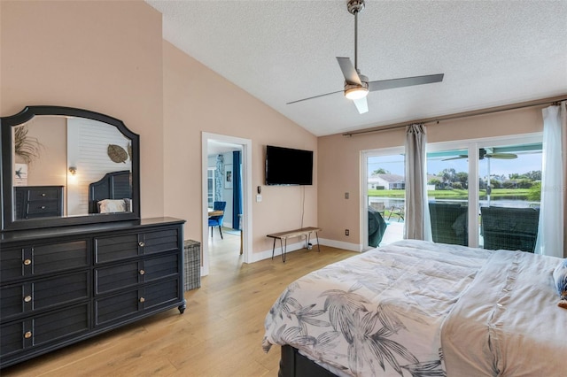 4120 51st Dr W, Bradenton, FL 34210 - bedroom featuring vaulted ceiling, access to outside, light wood-style flooring, a textured ceiling, and ceiling fan