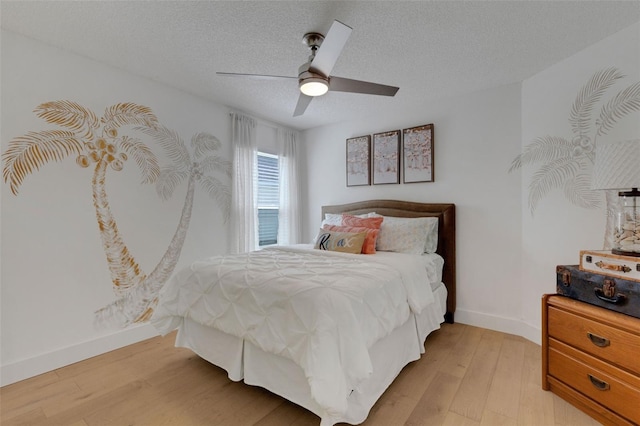 4120 51st Dr W, Bradenton, FL 34210 - bedroom featuring light wood-style floors, ceiling fan, and a textured ceiling
