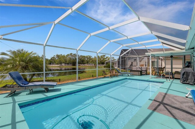 4120 51st Dr W, Bradenton, FL 34210 - outdoor pool featuring a patio, a water view, ceiling fan, a lanai, and a yard