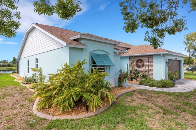 4120 51st Dr W, Bradenton, FL 34210 - view of front of property featuring stucco siding, a garage, a shingled roof, and a front yard