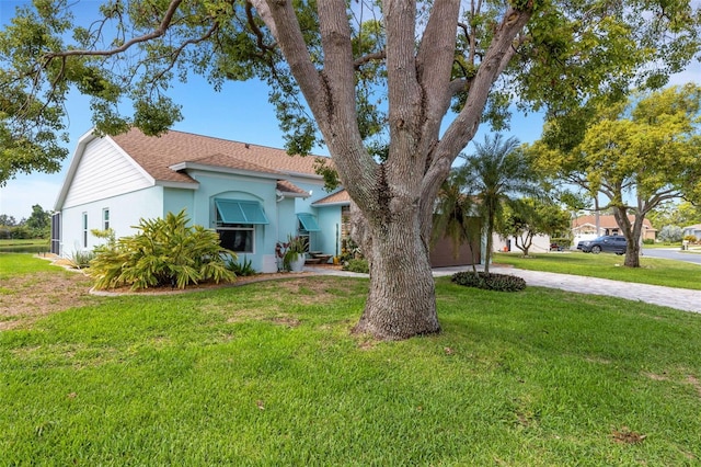 4120 51st Dr W, Bradenton, FL 34210 - mediterranean / spanish-style home with a front lawn, stucco siding, a shingled roof, and driveway