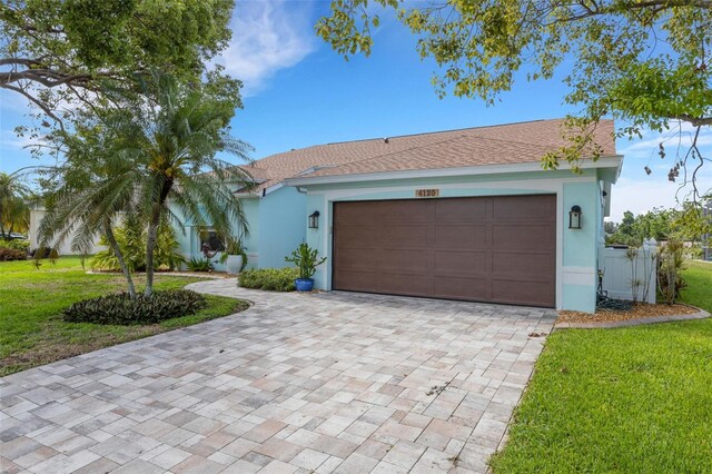 4120 51st Dr W, Bradenton, FL 34210 - view of front of home with decorative driveway, a front lawn, stucco siding, and a garage