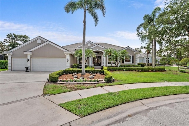 7513 Coventry Ct, Lakewood Ranch, FL 34202 - ranch-style house featuring driveway, a garage, a front lawn, and stucco siding