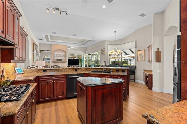 7513 Coventry Ct, Lakewood Ranch, FL 34202 - kitchen with a sink, reddish brown cabinets, dishwasher, black gas cooktop, and light wood-type flooring