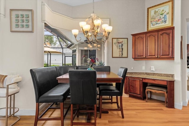 7513 Coventry Ct, Lakewood Ranch, FL 34202 - dining area with light wood finished floors, a chandelier, and baseboards
