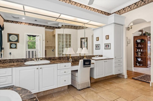 7513 Coventry Ct, Lakewood Ranch, FL 34202 - full bathroom with stone tile floors, ornamental molding, two vanities, and tiled shower
