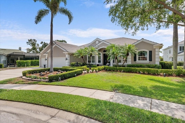 7513 Coventry Ct, Lakewood Ranch, FL 34202 - ranch-style home featuring an attached garage, stucco siding, a front yard, and concrete driveway