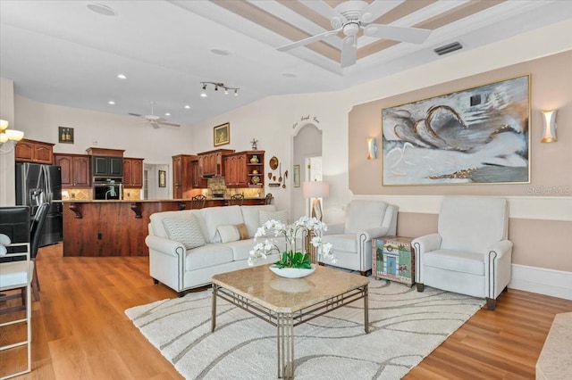 7513 Coventry Ct, Lakewood Ranch, FL 34202 - living room featuring ceiling fan, light wood-style flooring, arched walkways, and recessed lighting