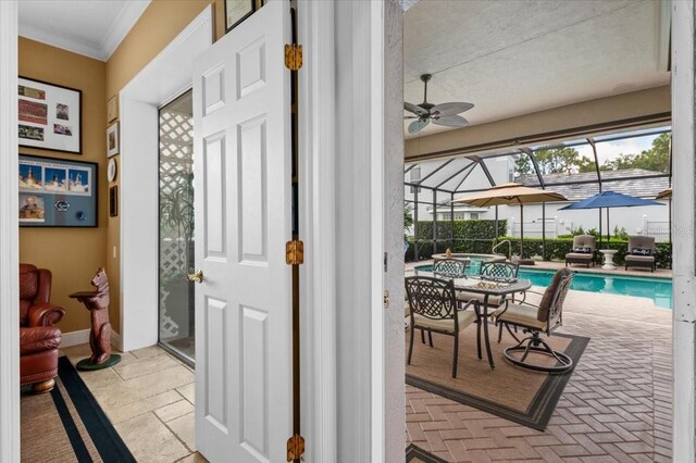 7513 Coventry Ct, Lakewood Ranch, FL 34202 - foyer entrance with a sunroom, a ceiling fan, and crown molding