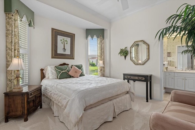 7513 Coventry Ct, Lakewood Ranch, FL 34202 - bedroom featuring light colored carpet, ornamental molding, ensuite bathroom, a sink, and baseboards