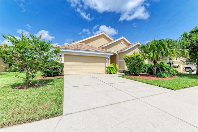 8772 Stone Harbour Loop, Bradenton, FL 34212 - view of front facade featuring stucco siding, a garage, driveway, a front lawn, and a tiled roof
