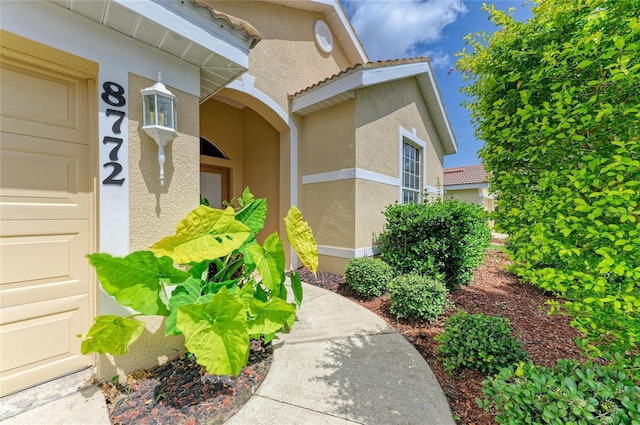 8772 Stone Harbour Loop, Bradenton, FL 34212 - doorway to property featuring stucco siding and a tile roof