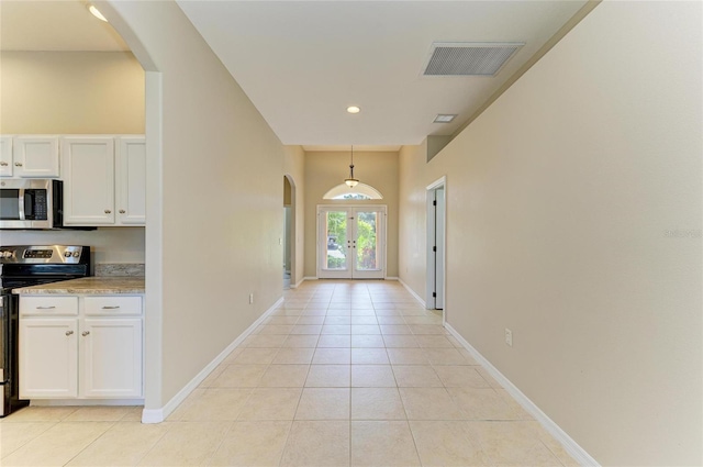 8772 Stone Harbour Loop, Bradenton, FL 34212 - corridor with arched walkways, french doors, light tile patterned flooring, and recessed lighting