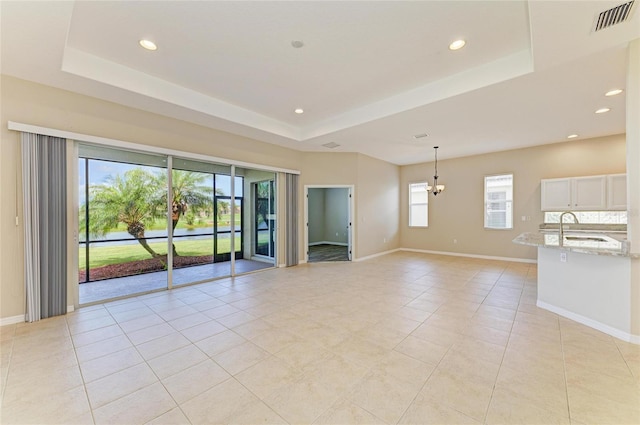 8772 Stone Harbour Loop, Bradenton, FL 34212 - spare room featuring a tray ceiling, recessed lighting, and light tile patterned floors