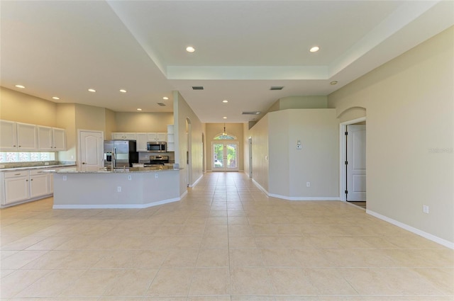 8772 Stone Harbour Loop, Bradenton, FL 34212 - kitchen featuring appliances with stainless steel finishes, light tile patterned flooring, white cabinetry, healthy amount of natural light, and recessed lighting