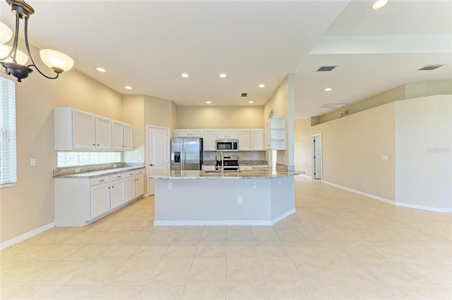 8772 Stone Harbour Loop, Bradenton, FL 34212 - kitchen with appliances with stainless steel finishes, light tile patterned floors, white cabinetry, recessed lighting, and light stone countertops