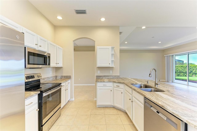 8772 Stone Harbour Loop, Bradenton, FL 34212 - kitchen featuring appliances with stainless steel finishes, open shelves, arched walkways, white cabinets, and recessed lighting