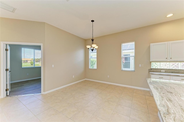 8772 Stone Harbour Loop, Bradenton, FL 34212 - unfurnished dining area featuring plenty of natural light, light tile patterned floors, a chandelier, and lofted ceiling