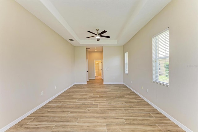 8772 Stone Harbour Loop, Bradenton, FL 34212 - unfurnished room with ceiling fan, a tray ceiling, and light wood-type flooring