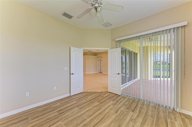 8772 Stone Harbour Loop, Bradenton, FL 34212 - unfurnished room with light wood finished floors, ceiling fan, and arched walkways