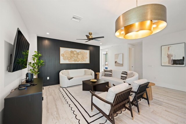 109 Palmetto Ave, Anna Maria, FL 34216 - living room with light wood-style floors, a ceiling fan, baseboards, recessed lighting, and an accent wall