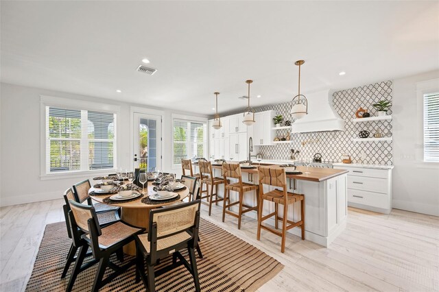109 Palmetto Ave, Anna Maria, FL 34216 - dining room featuring recessed lighting, baseboards, and light wood-style floors