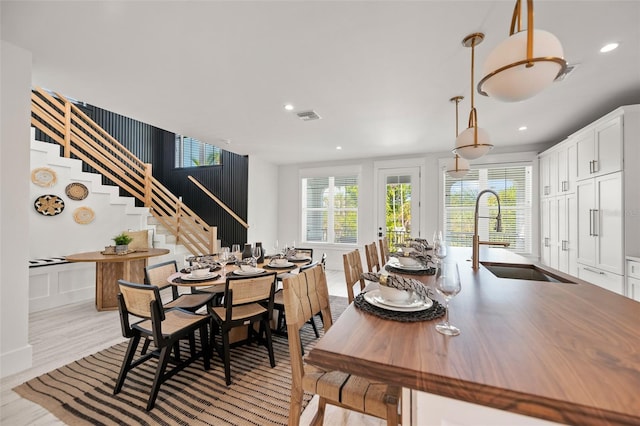 109 Palmetto Ave, Anna Maria, FL 34216 - dining room with stairs, light wood-type flooring, and recessed lighting