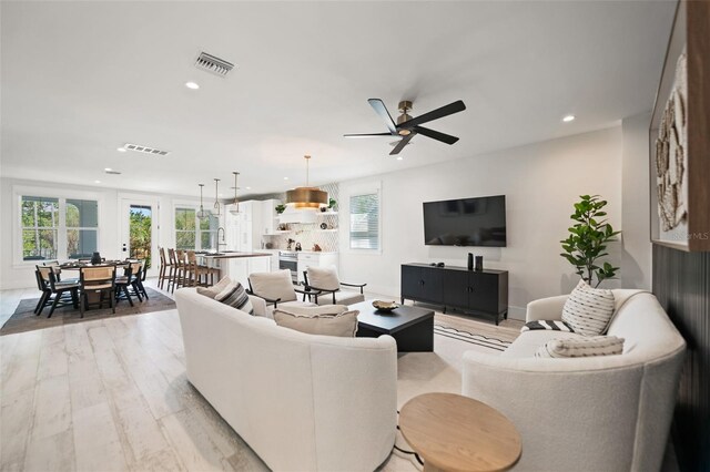 109 Palmetto Ave, Anna Maria, FL 34216 - living area with recessed lighting, light wood-style flooring, healthy amount of natural light, a ceiling fan, and baseboards