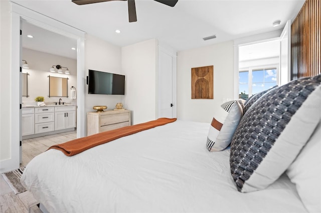 109 Palmetto Ave, Anna Maria, FL 34216 - bedroom featuring ensuite bath, recessed lighting, a sink, ceiling fan, and light wood-type flooring