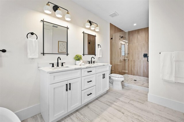 109 Palmetto Ave, Anna Maria, FL 34216 - bathroom featuring double vanity, tiled shower, baseboards, toilet, and recessed lighting