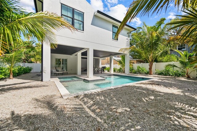 109 Palmetto Ave, Anna Maria, FL 34216 - rear view of house with stucco siding, a patio area, a fenced backyard, and a pool with connected hot tub